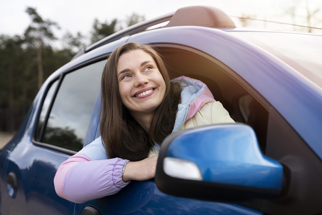 woman smiling in car window
